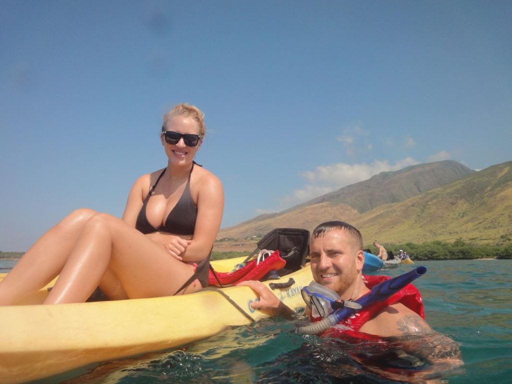 Kayak and snorkel tour on clear West Maui waters near Olowalu Beach with guests paddling toward coral reef