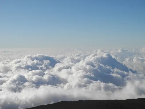 View from Haleakalā summit above the cloud layer Maui visible below at 10,023 feet elevation