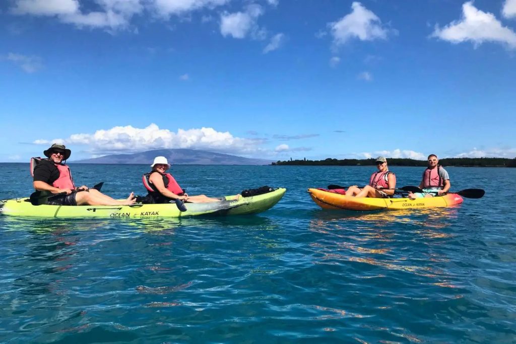 Maui Adventure Tours Kayak Co. guests kayaking at Olowalu Beach with West Maui Mountains in the background during a guided kayak and snorkel tour