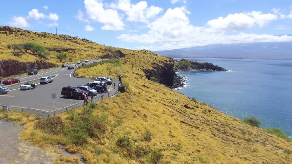 Roadside parking pull-off at Olowalu Beach near Mile Marker 14, Honoapi'ilani Highway, West Maui, showing gravel shoulder and kiawe trees